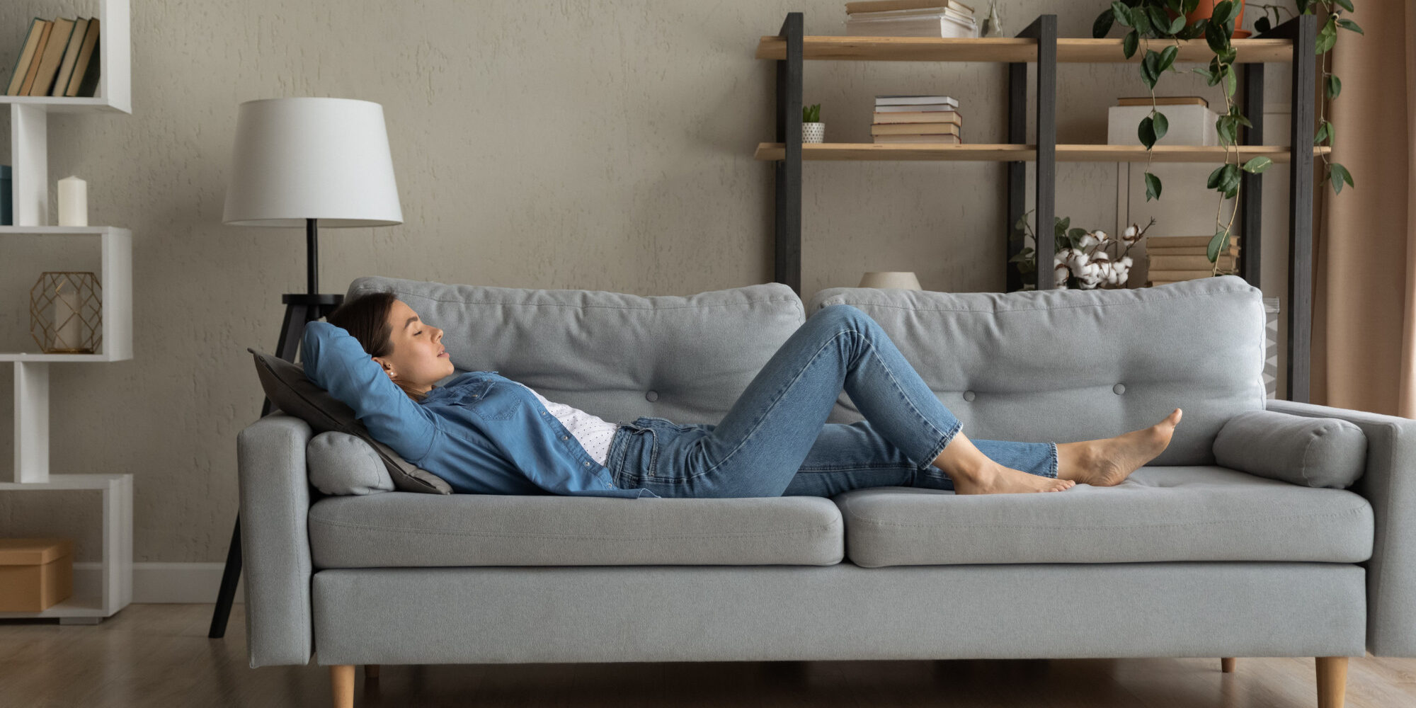 Side view woman enjoy day nap on comfy sofa