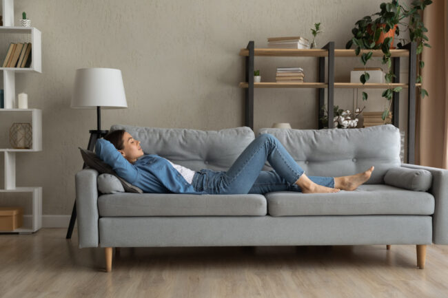 Side view woman enjoy day nap on comfy sofa